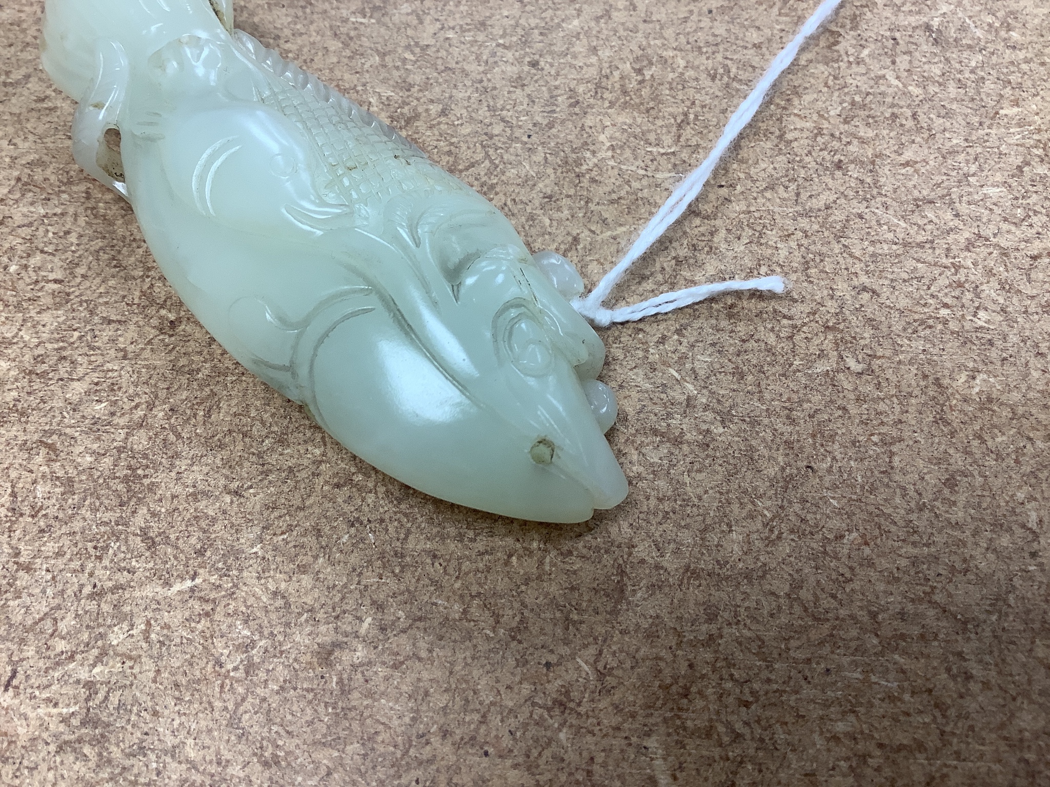 A Chinese pale celadon jade carving of a fish, 8.7 cm